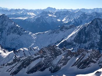 Aerial view of snowcapped mountains against sky