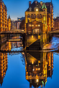 Reflection of illuminated buildings in river at night