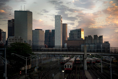 Cityscape against cloudy sky during sunset