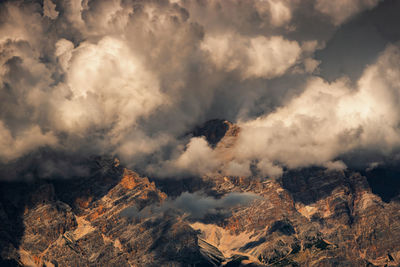 Scenic view of rocky mountains against cloudy sky