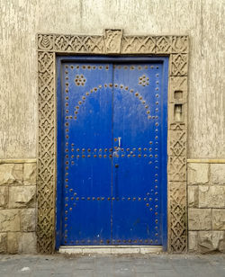 Closed blue door of old building