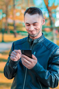 Mid adult man using mobile phone