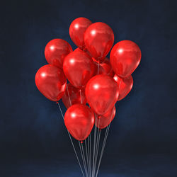 Close-up of red balloons against black background