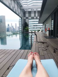 Low section of woman legs in swimming pool