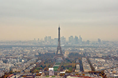 Aerial view of buildings in city against sky