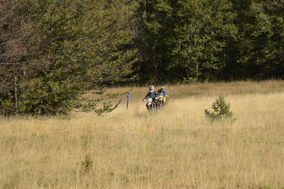 People riding motorcycle on field