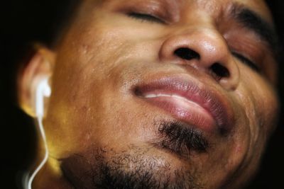 Close-up of man wearing in-ear headphones