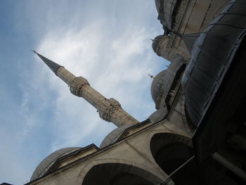 Low angle view of building against cloudy sky