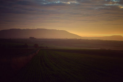 Scenic view of field against sky during sunset