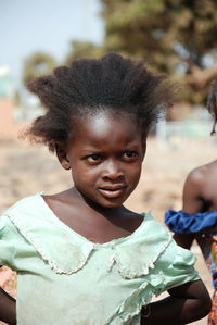 Close-up of girl looking away while standing outdoors