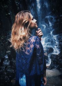 Woman looking at waterfall