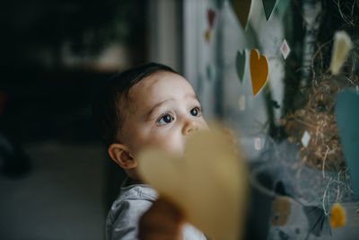 Portrait of cute boy looking away at home