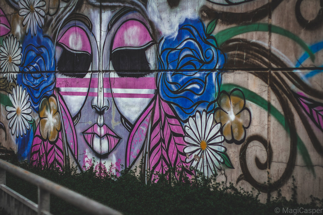 CLOSE-UP OF GRAFFITI ON WALL WITH WINDOWS