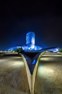 Close-up of illuminated car against blue sky at night