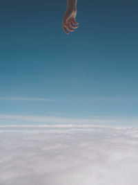 Low section of man in sea against sky