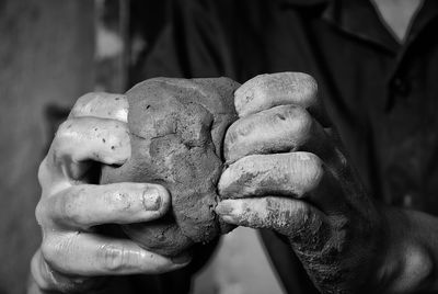 Close-up of man holding statue