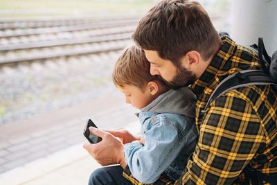 Side view of man using mobile phone