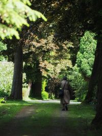 Rear view of people walking on footpath