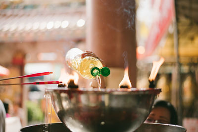 Close-up of hand pouring wine in glass