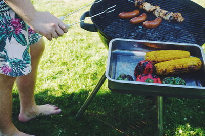 High angle view of man preparing food on barbecue grill