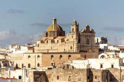 Buildings in city against sky