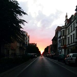 View of city street at sunset