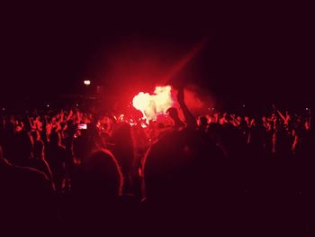 People enjoying music concert at night