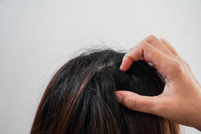 Close-up portrait of woman hand over white background