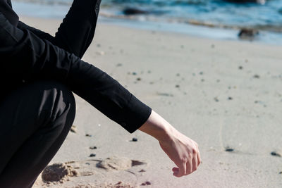 Midsection of man standing on beach