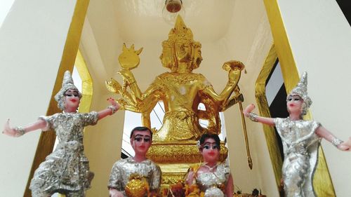 Low angle view of statue against temple