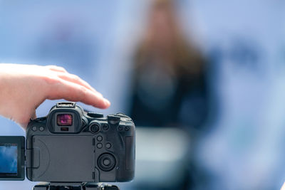 Cropped hand holding camera