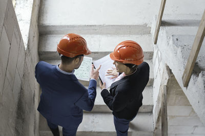 Architects examining blue print at site