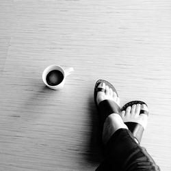 Low section of woman standing on tiled floor