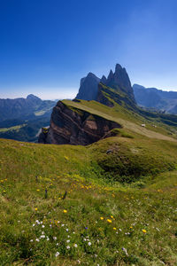 Scenic view of mountains against blue sky