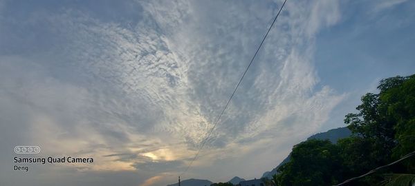 Low angle view of road sign against sky