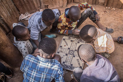 High angle view of boys playing board game