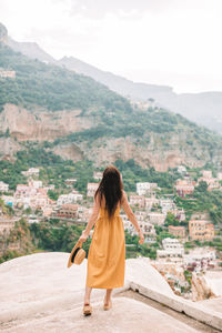 Rear view of woman looking at mountains