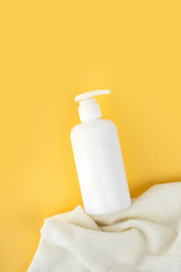 Natural hypoallergenic foam for bathing children. pump bottle.children's cosmetics.yellow.copy space