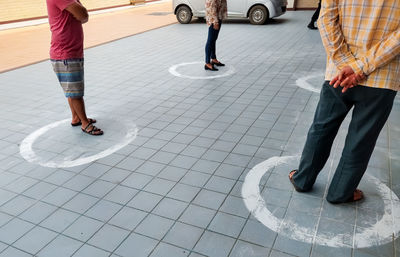 Low section of people walking on street