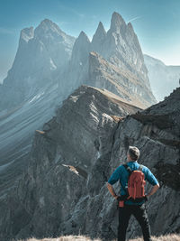 Rear view of man standing on mountain