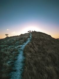 Scenic view of land against sky at sunset