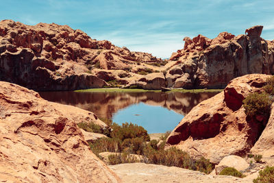 Scenic view of lake and mountains against sky