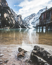 Scenic view of lake and snowcapped mountains against sky