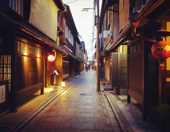 Narrow street amidst buildings in city