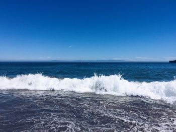 Scenic view of sea against clear blue sky