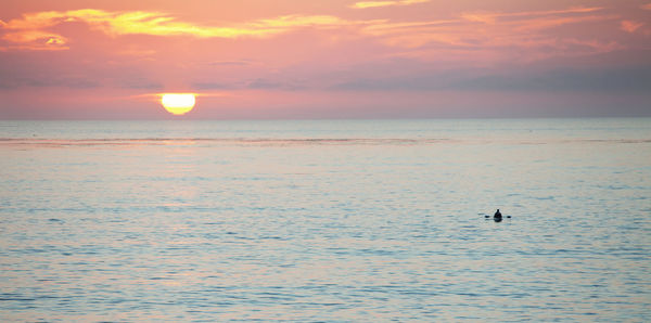 Scenic view of sea against sky at sunset