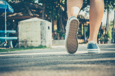 Low section of person walking on street