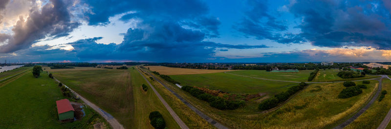 Panoramic shot of agricultural field against sky