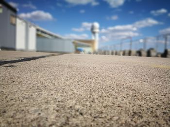 Surface level of road amidst buildings against sky