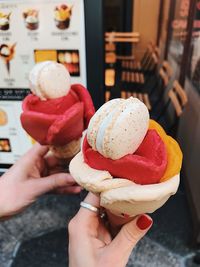 Cropped hands of women holding ice cream cones